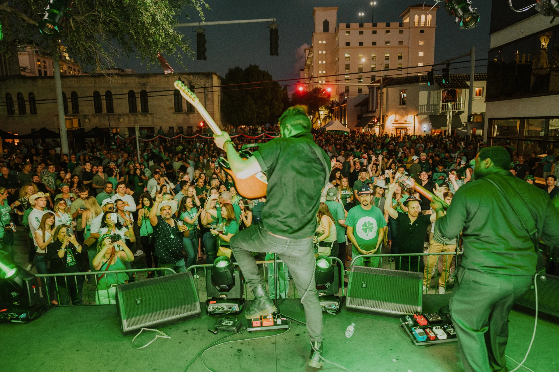 Nighttime view from the stage at John Martin’s St. Patrick’s Street Festival, with live musicians, lighting, stage monitors and the crowd in Coral Gables